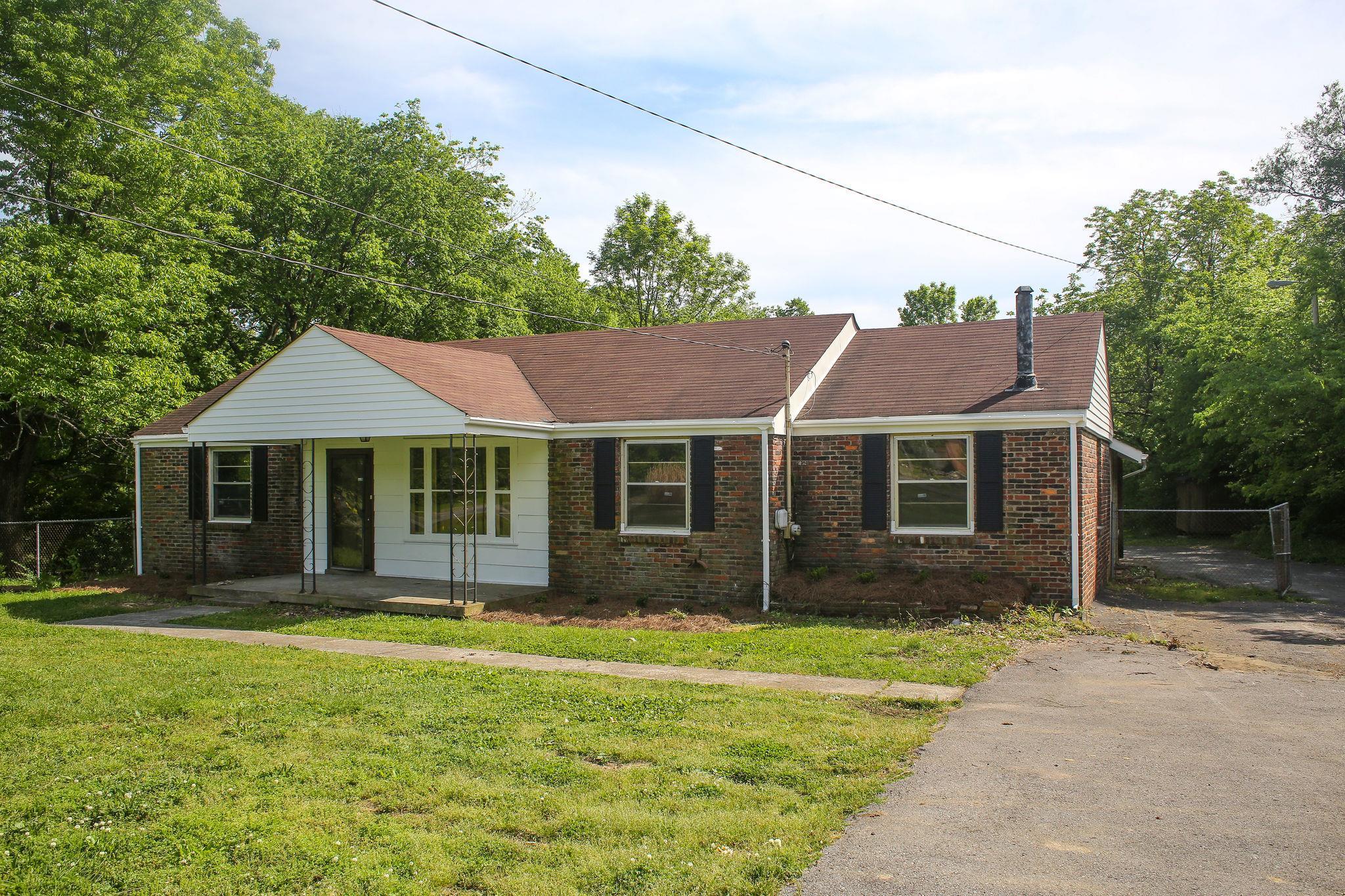 1008 Neelys Bend Road Madison, TN 37115 - Photo 2 of 26 a front view of a house with a garden