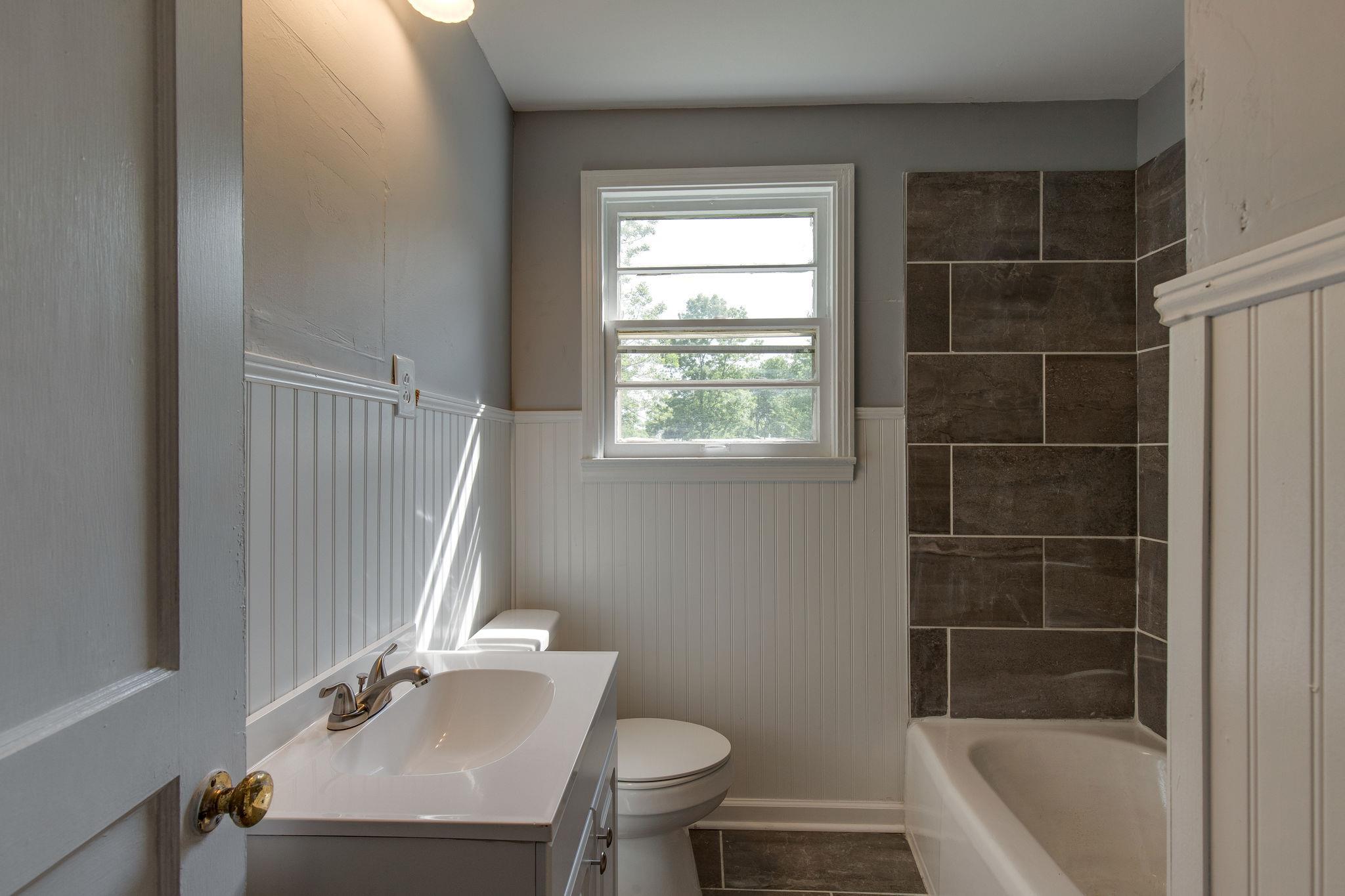 1008 Neelys Bend Road Madison, TN 37115 - Photo 16 of 26 a bathroom with a sink toilet and shower