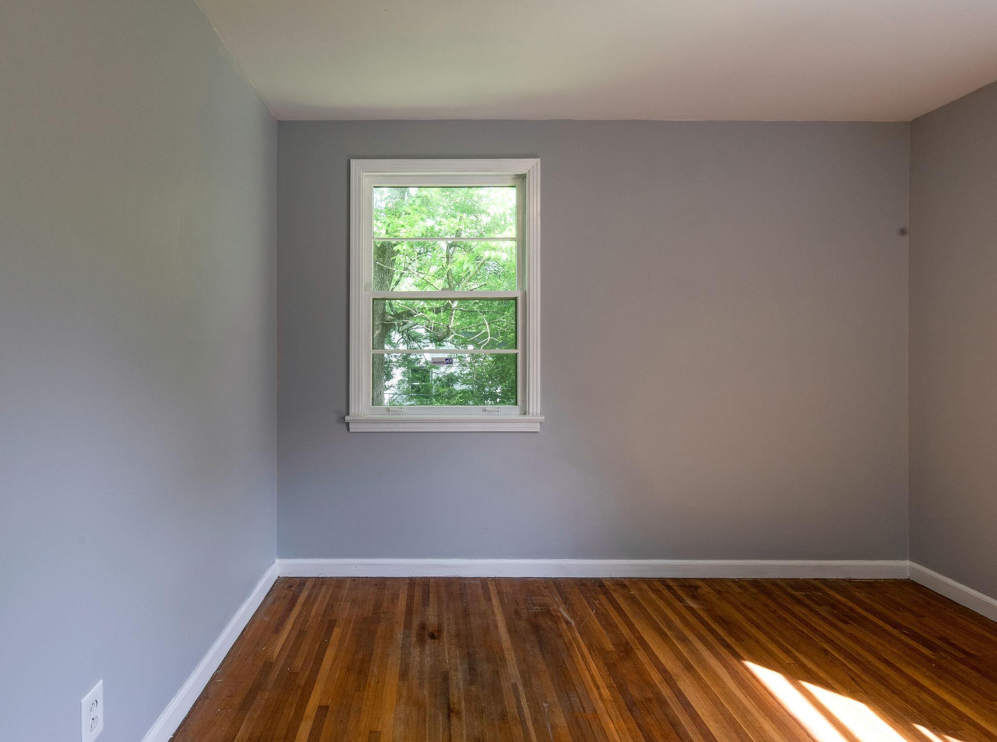 1008 Neelys Bend Road Madison, TN 37115 - Photo 17 of 26 an empty room with wooden floor and windows