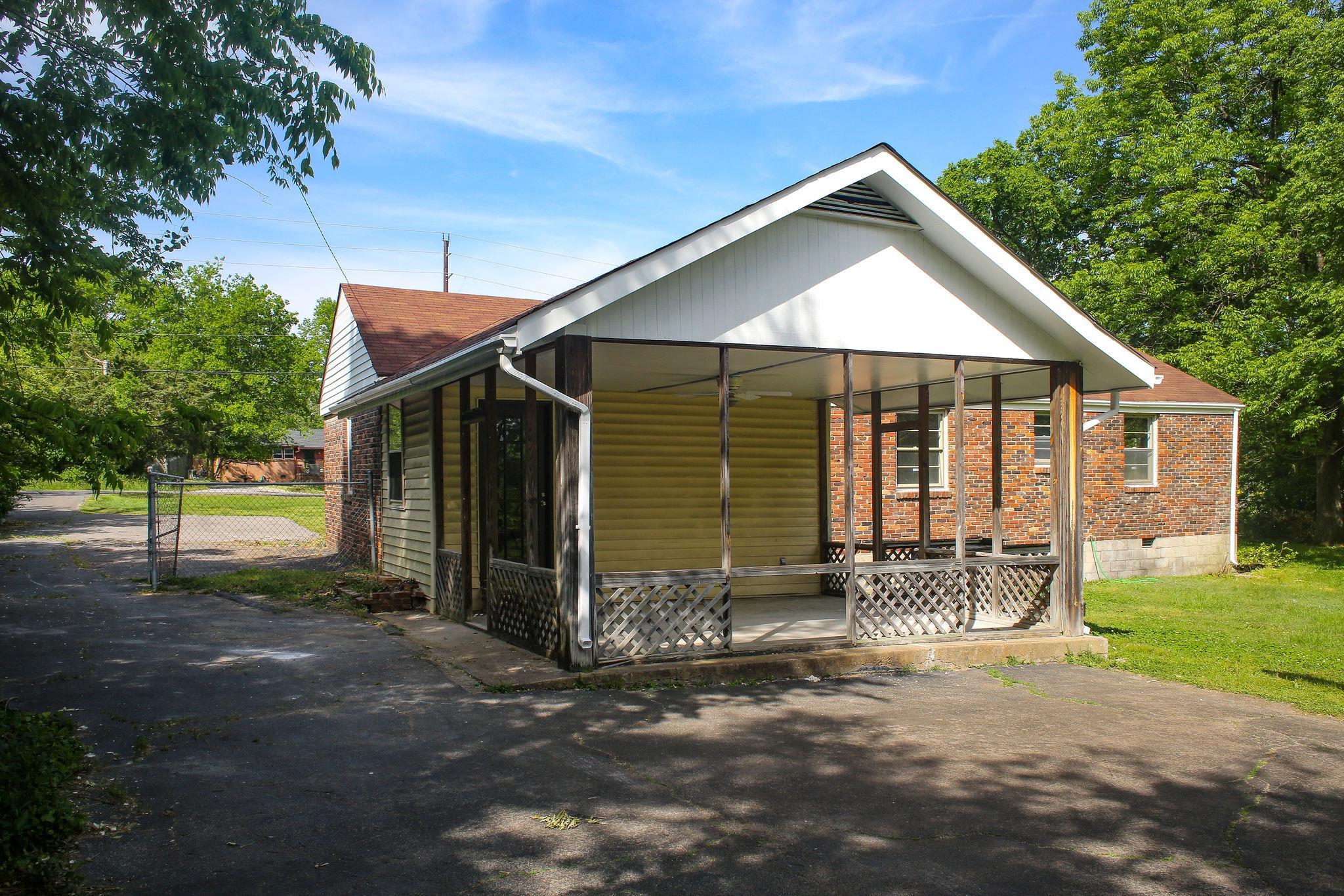 1008 Neelys Bend Road Madison, TN 37115 - Photo 23 of 26 a front view of a house with a yard and garage