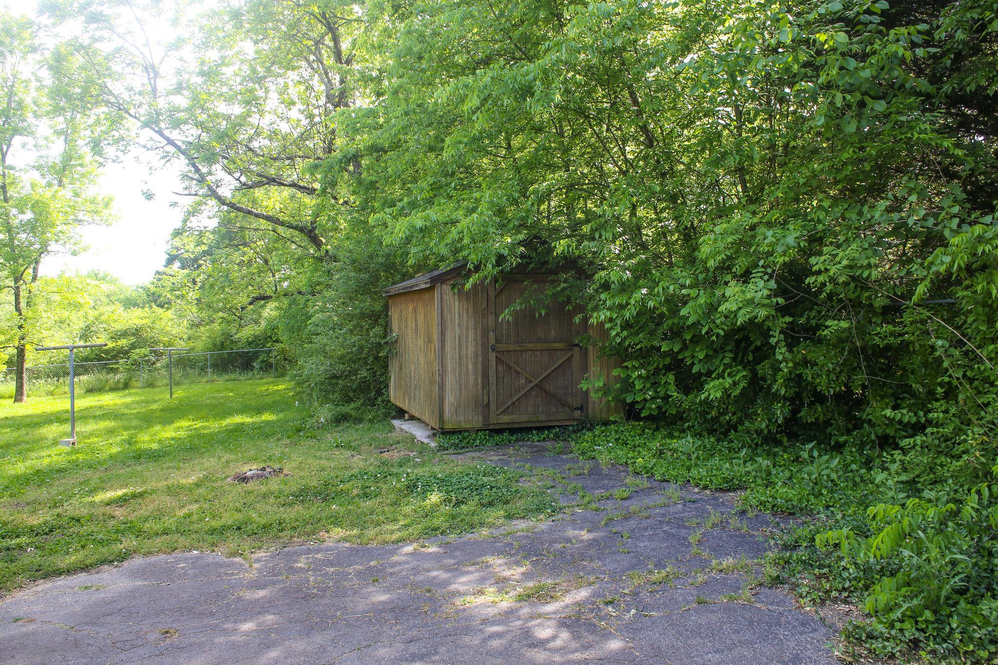 1008 Neelys Bend Road Madison, TN 37115 - Photo 26 of 26 a backyard of a house with plants and large trees