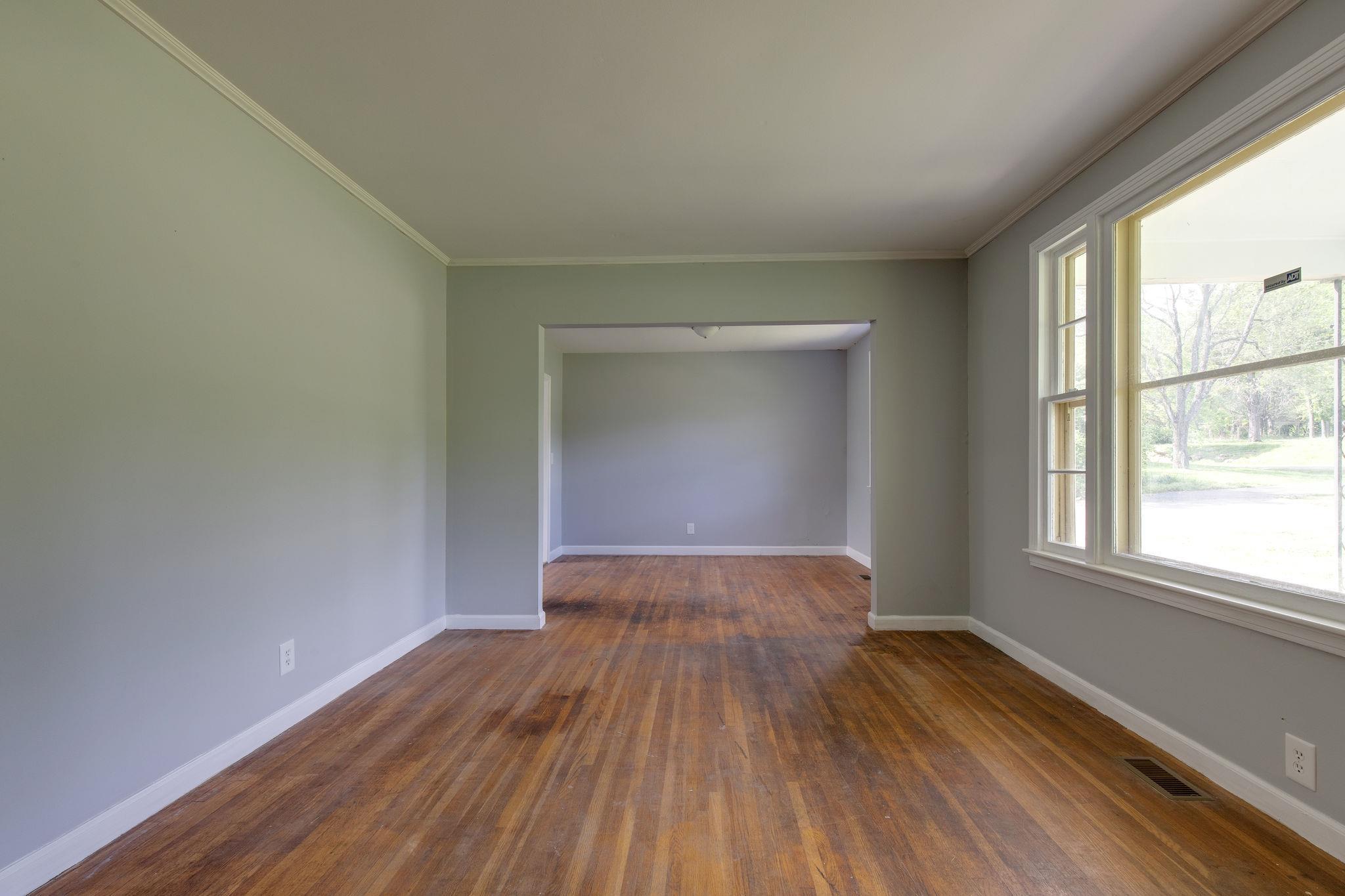 1008 Neelys Bend Road Madison, TN 37115 - Photo 4 of 26 an empty room with wooden floor and windows