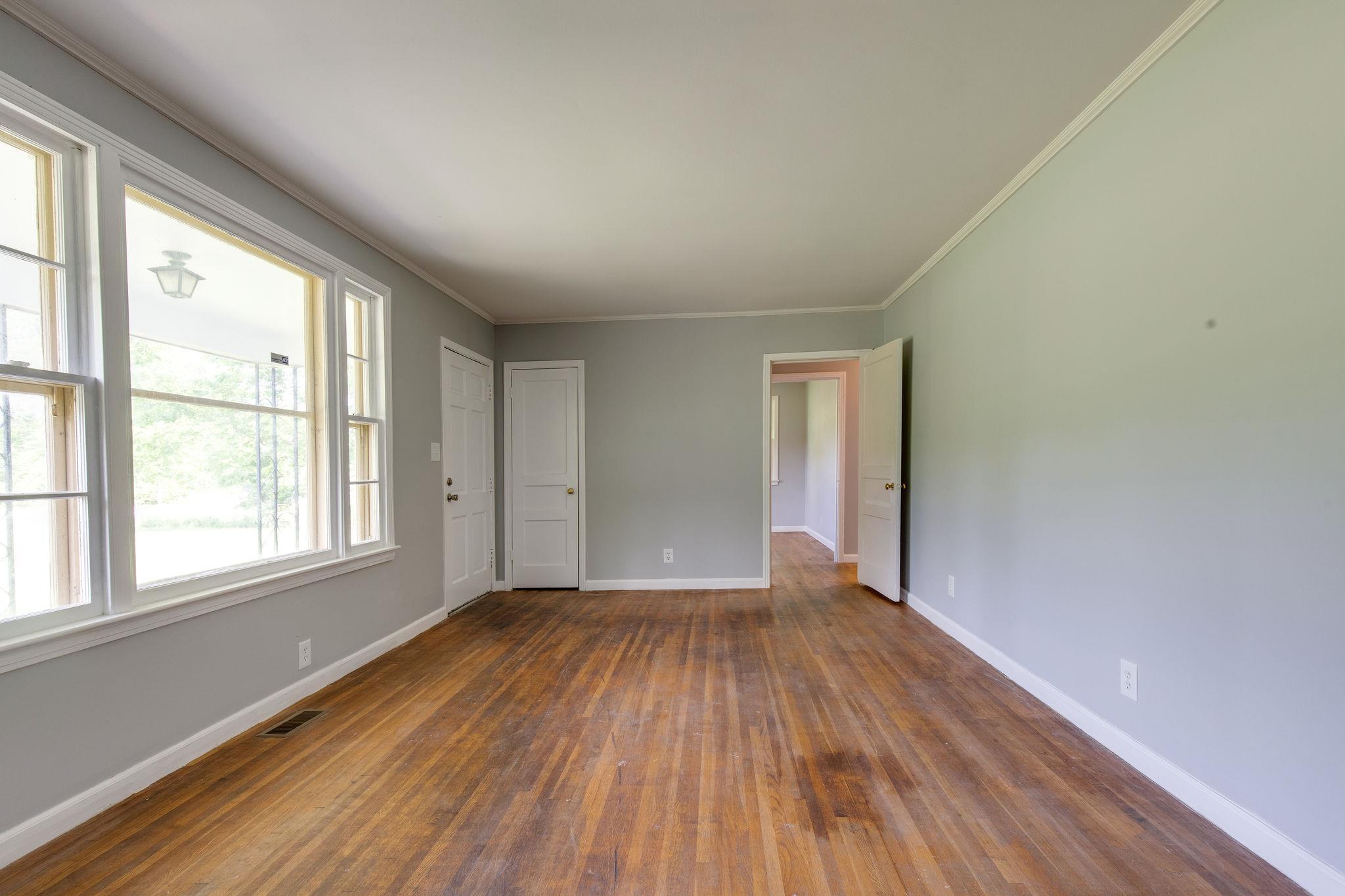 1008 Neelys Bend Road Madison, TN 37115 - Photo 5 of 26 an empty room with wooden floor and windows