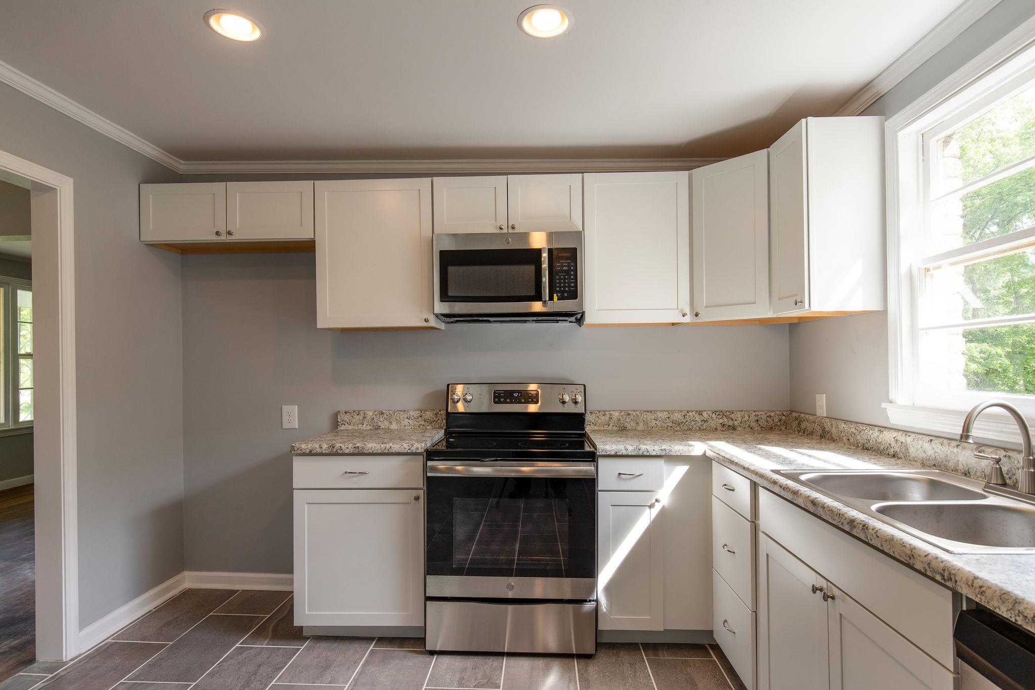 1008 Neelys Bend Road Madison, TN 37115 - Photo 9 of 26 a kitchen with a sink stove and microwave