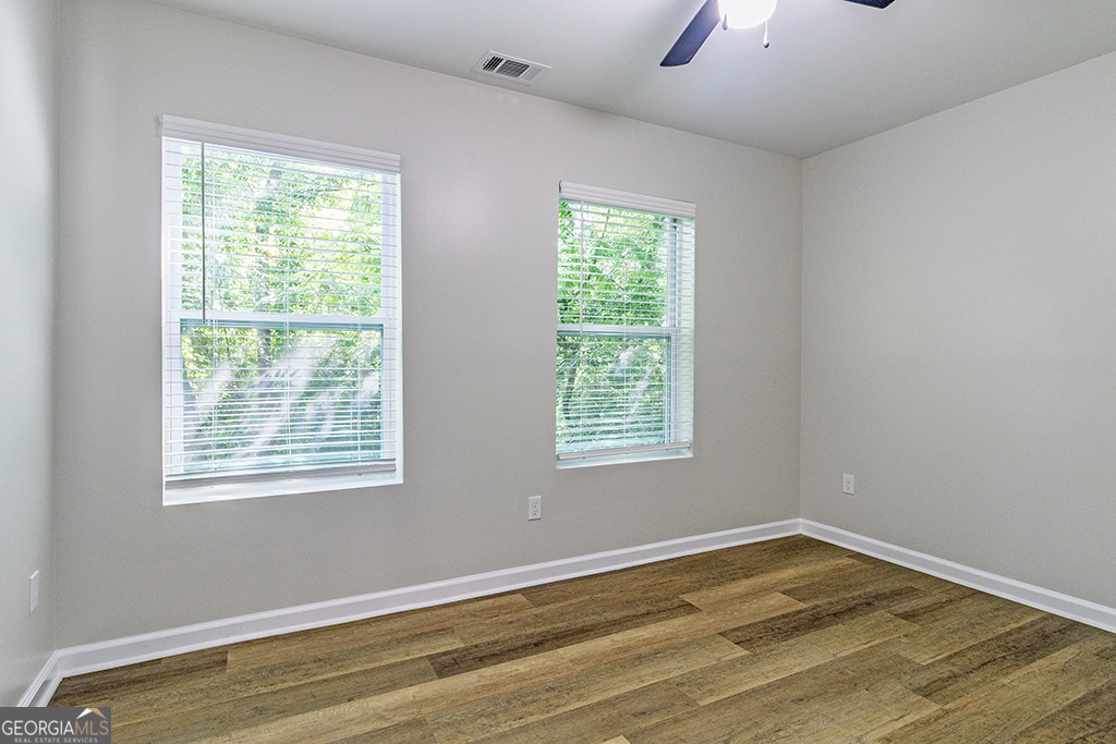 789 Main Street Macon, GA 31217 - Photo 13 of 19 a view of an empty room with wooden floor and a window