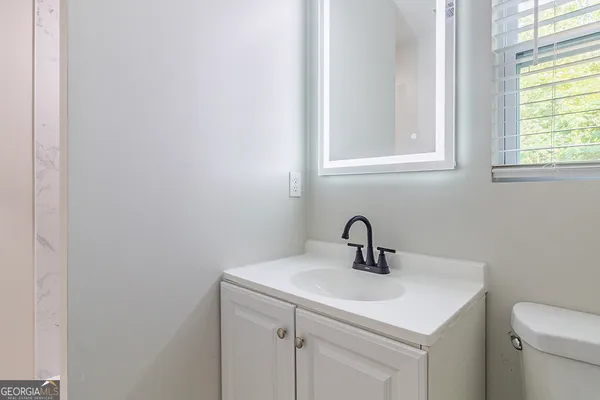 a bathroom with a sink a mirror and vanity