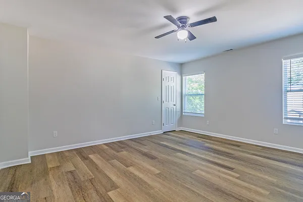 wooden floor in an empty room with a window