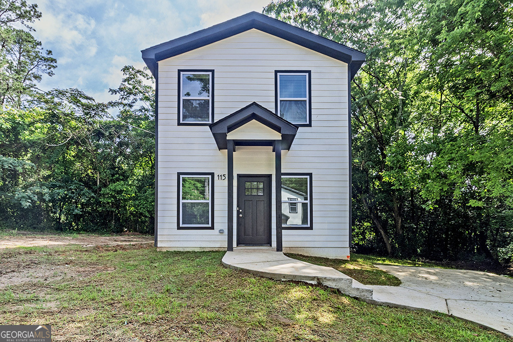 789 Main Street Macon, GA 31217 - Photo 2 of 19 a front view of a house with a yard and garage