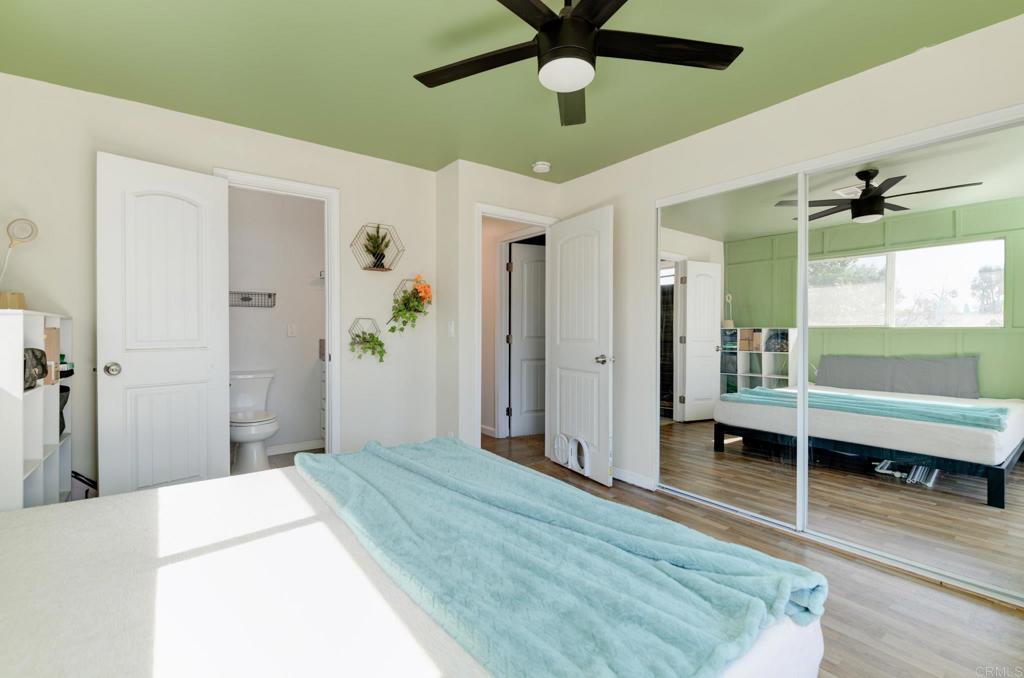 611 San Juhn Street Spring Valley, CA 91977 - Photo 13 of 25 a bedroom with a bed and a chandelier