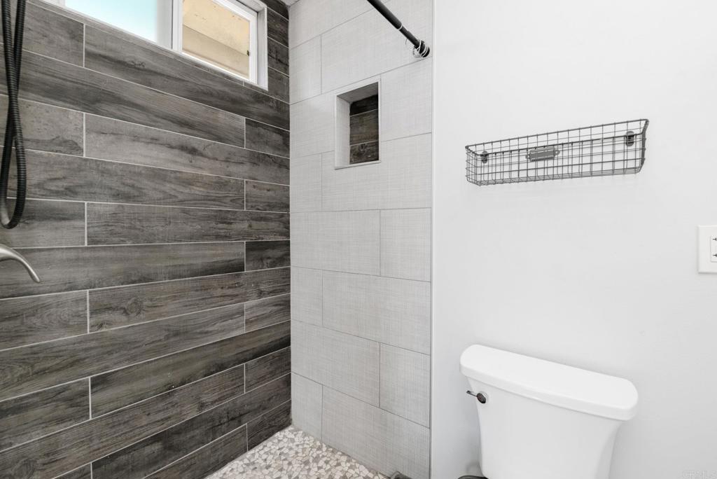 611 San Juhn Street Spring Valley, CA 91977 - Photo 15 of 25 a bathroom with a toilet and a shower