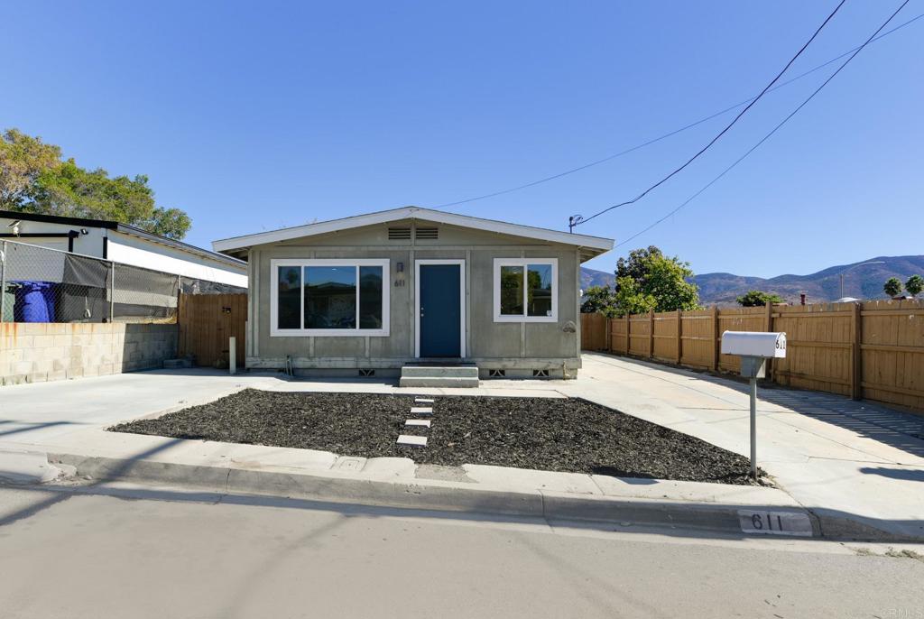 611 San Juhn Street Spring Valley, CA 91977 - Photo 20 of 25 a front view of a house with a yard and garage