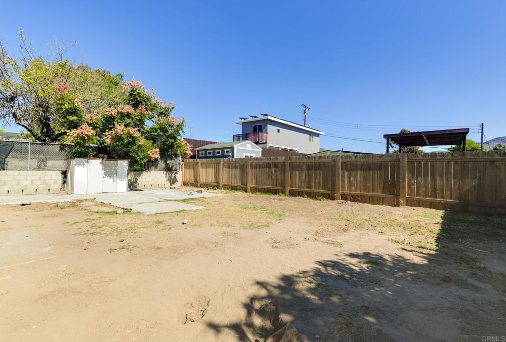 611 San Juhn Street Spring Valley, CA 91977 - Photo 22 of 25 a wooden bench sitting in the middle of a yard