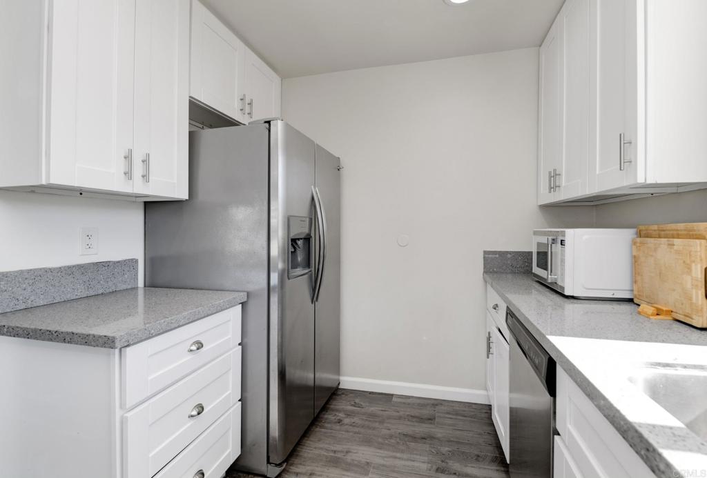 611 San Juhn Street Spring Valley, CA 91977 - Photo 4 of 25 a kitchen with stainless steel appliances granite countertop a sink stove and refrigerator