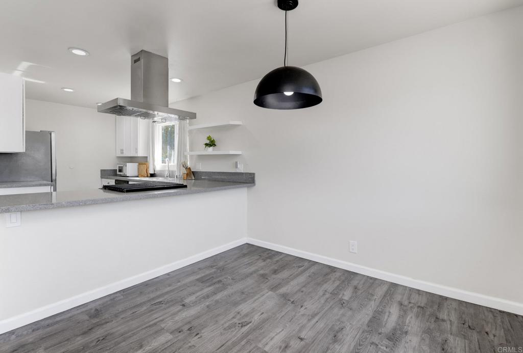 611 San Juhn Street Spring Valley, CA 91977 - Photo 7 of 25 a room with lots of counter space and a ceiling fan