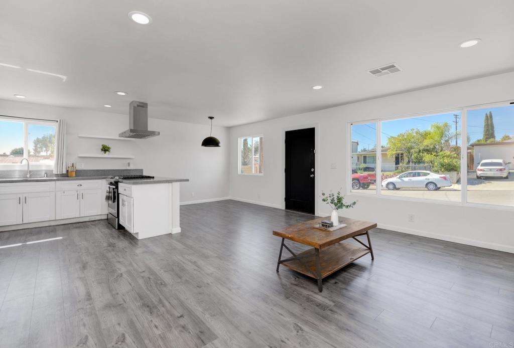 611 San Juhn Street Spring Valley, CA 91977 - Photo 9 of 25 a living room with stainless steel appliances kitchen island hardwood floor and a kitchen view
