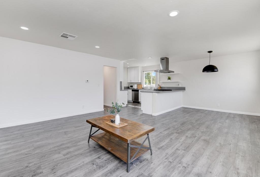 611 San Juhn Street Spring Valley, CA 91977 - Photo 10 of 25 a living room with kitchen island furniture and a kitchen view