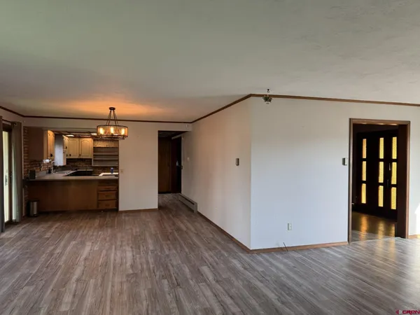 a view of a kitchen with a sink and a refrigerator