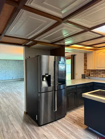 a kitchen with kitchen island wooden cabinets a sink and a stove