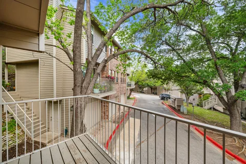 a view of balcony with small trees