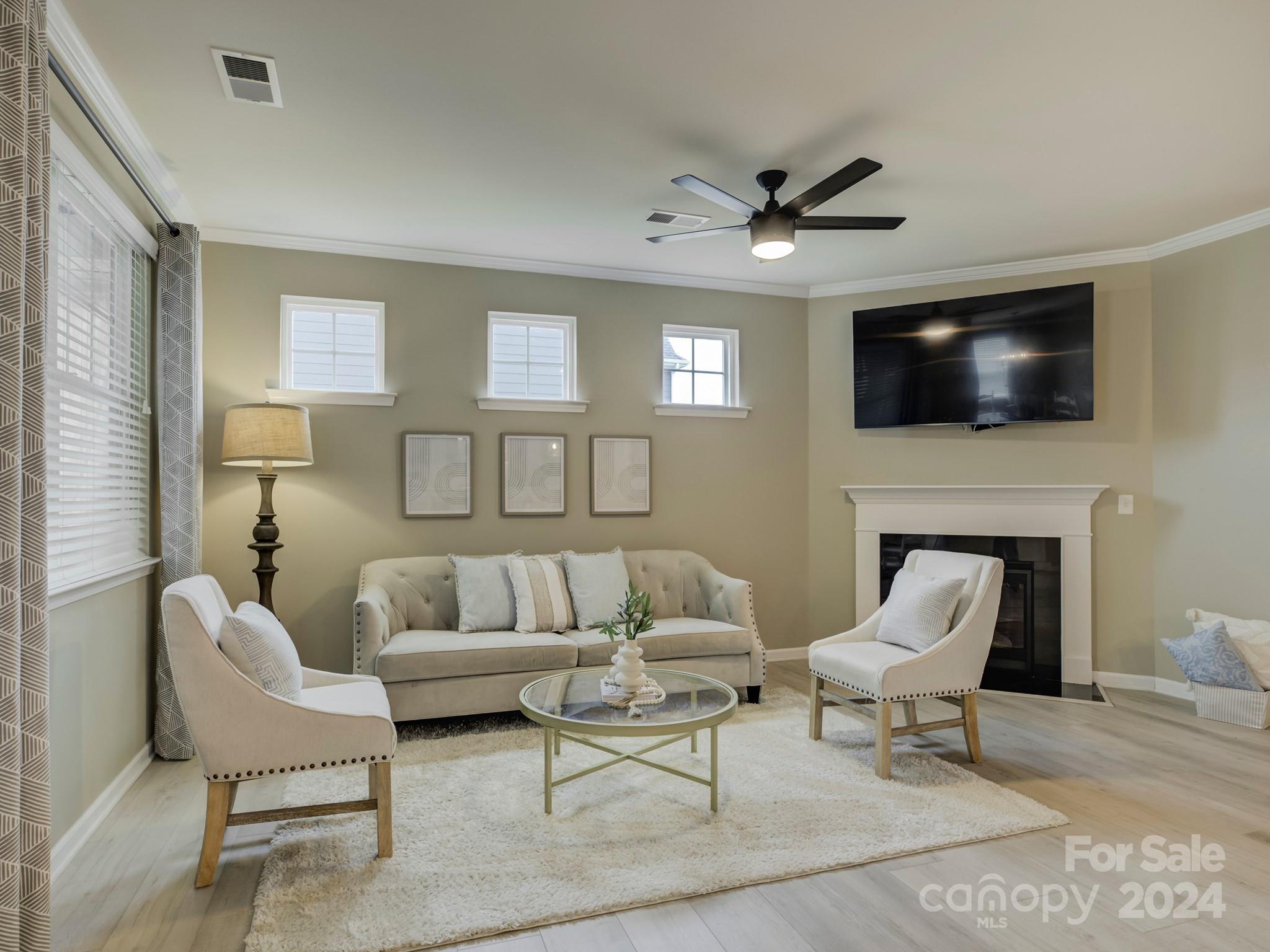 405 Cotton Field Road Indian Land, SC 29707 - Photo 11 of 48 a living room with furniture a fireplace and a flat screen tv
