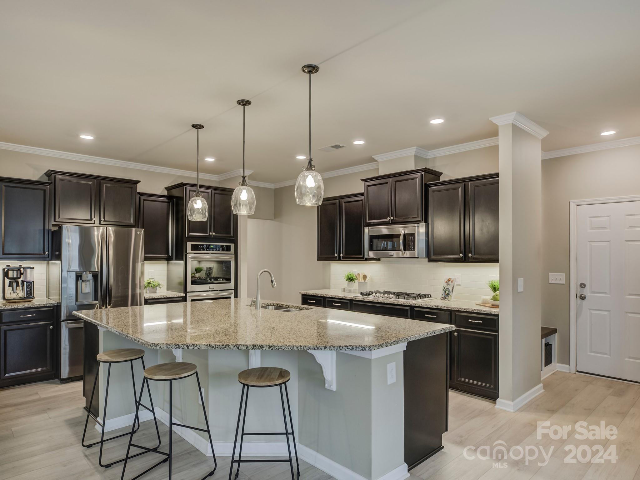 405 Cotton Field Road Indian Land, SC 29707 - Photo 14 of 48 a kitchen with stainless steel appliances kitchen island granite countertop a sink and a refrigerator