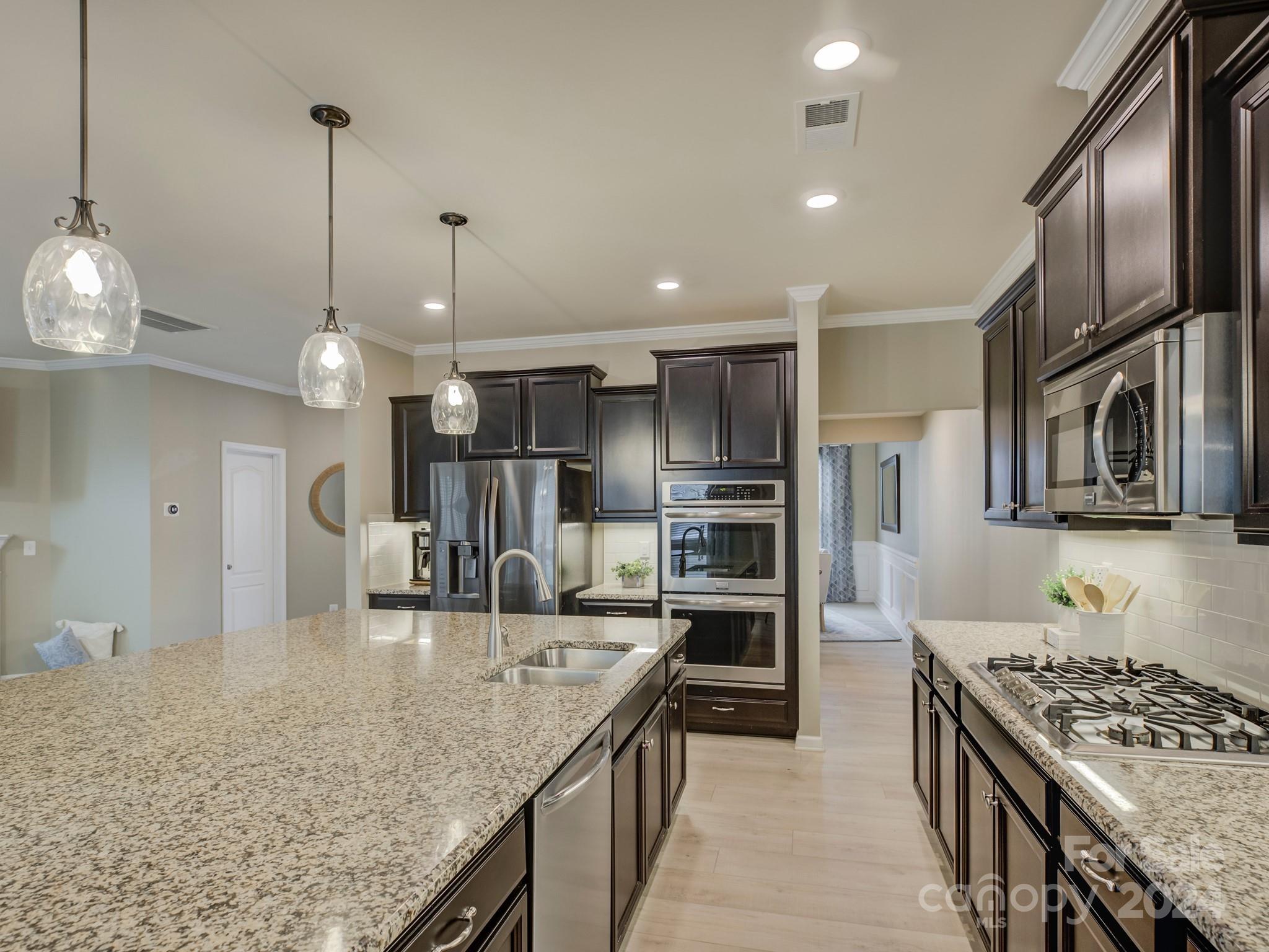 405 Cotton Field Road Indian Land, SC 29707 - Photo 15 of 48 a kitchen with stainless steel appliances granite countertop a sink stove and refrigerator
