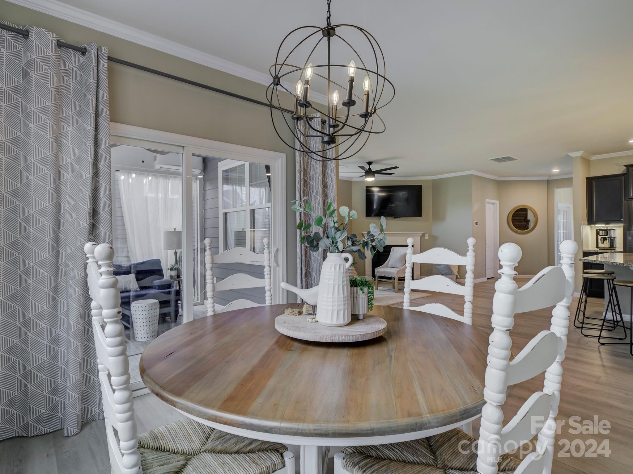 405 Cotton Field Road Indian Land, SC 29707 - Photo 19 of 48 a dining room with wooden floor a chandelier a glass table and chairs