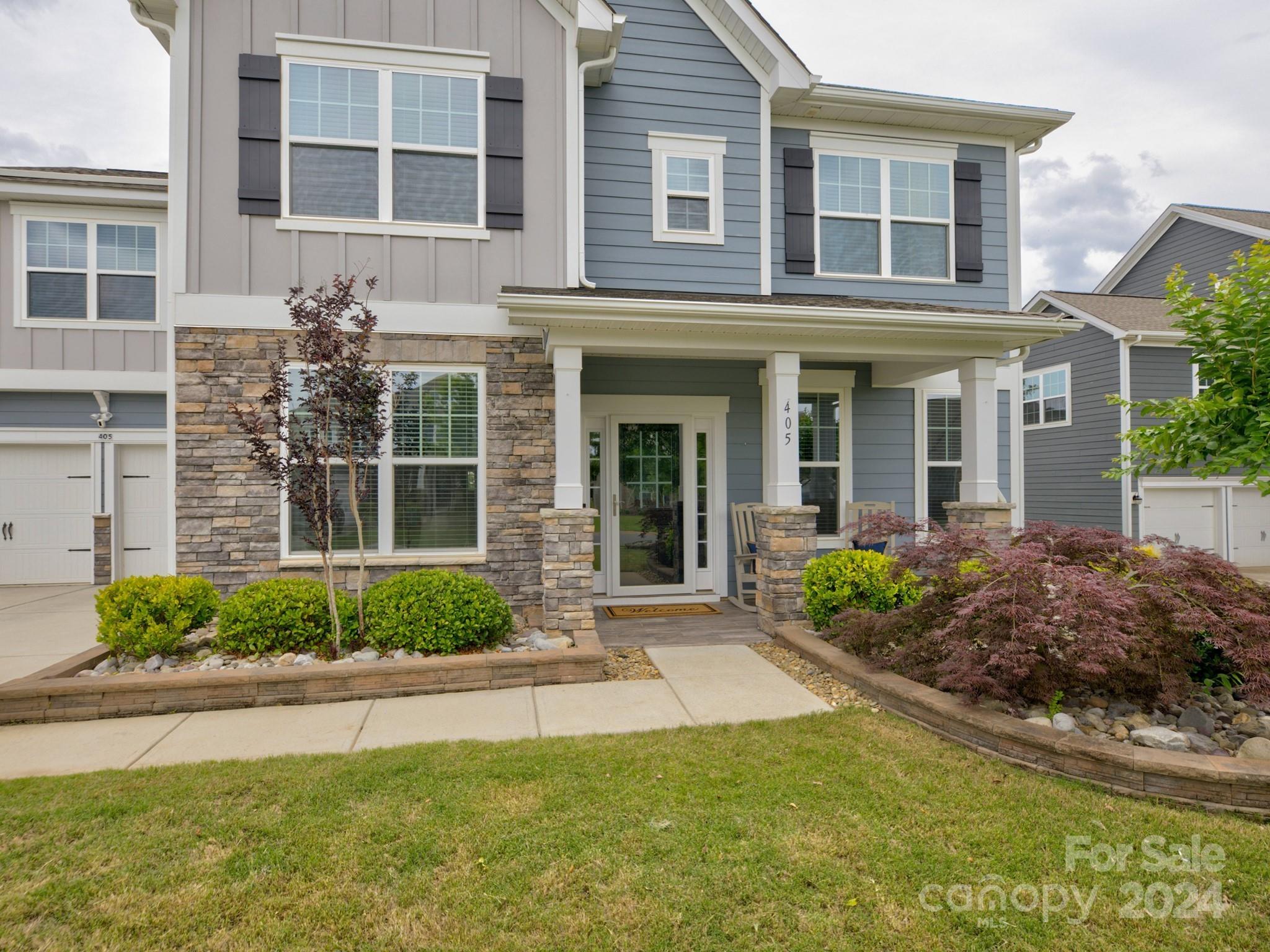 405 Cotton Field Road Indian Land, SC 29707 - Photo 2 of 48 a front view of a brick house with a yard and potted plants