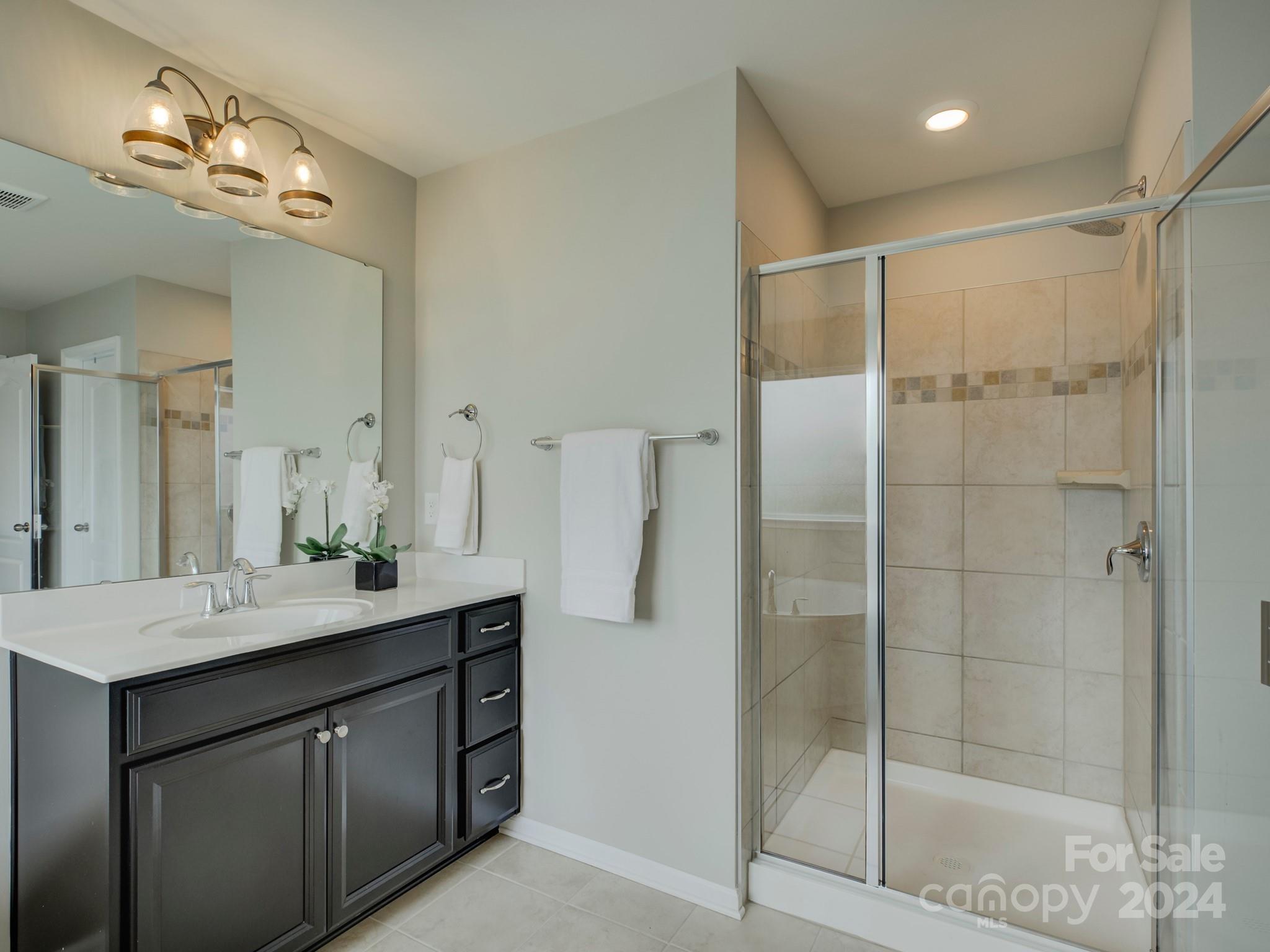 405 Cotton Field Road Indian Land, SC 29707 - Photo 28 of 48 a bathroom with a shower sink and mirror