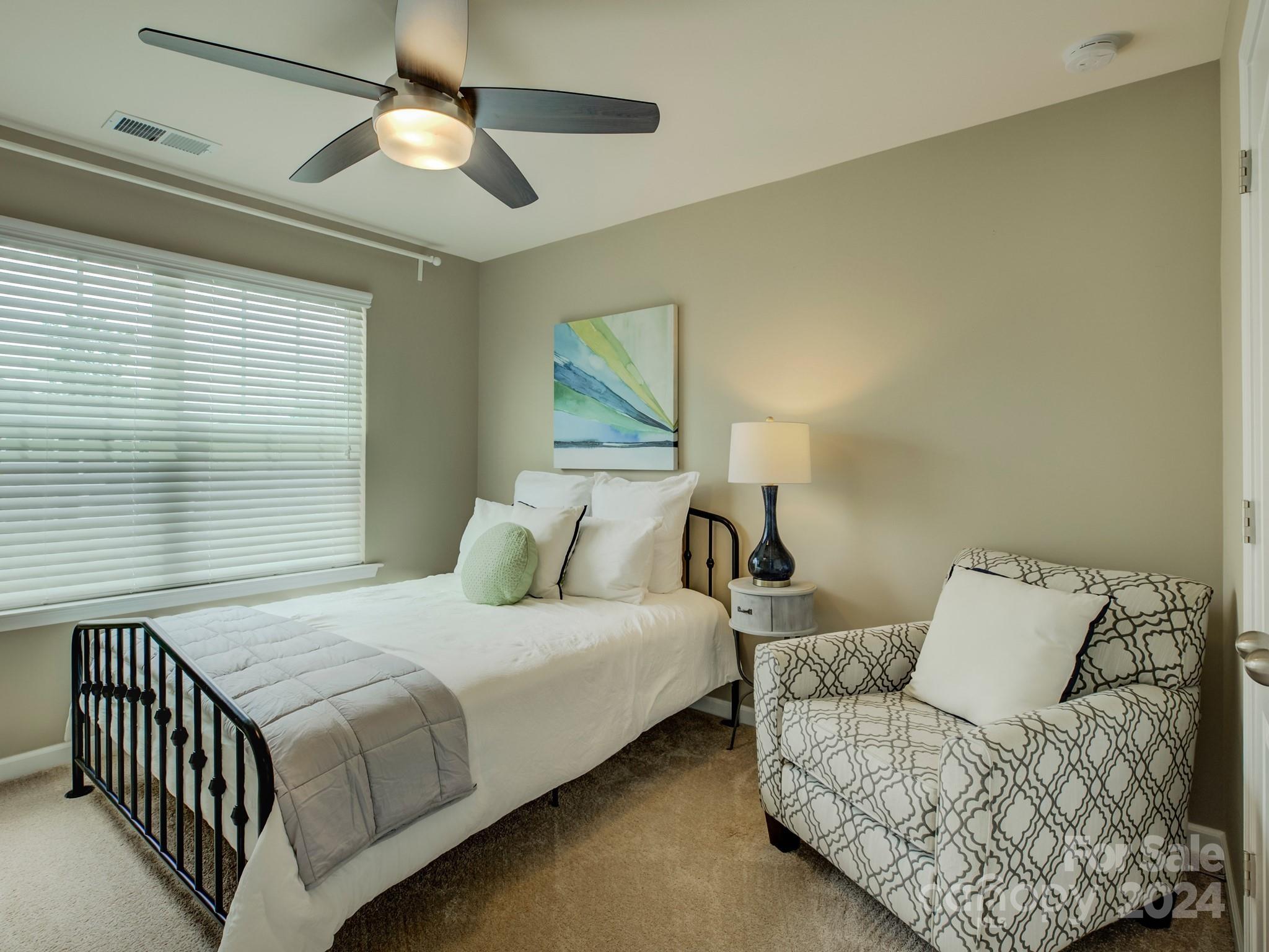 405 Cotton Field Road Indian Land, SC 29707 - Photo 31 of 48 a bedroom with a bed and a chandelier