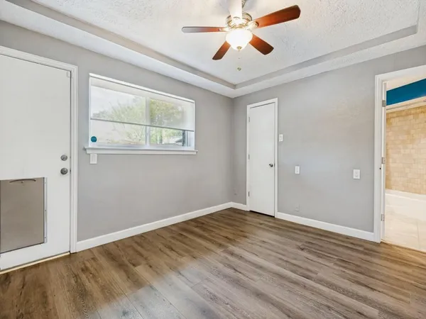 a bathroom with a granite countertop sink and a bathtub