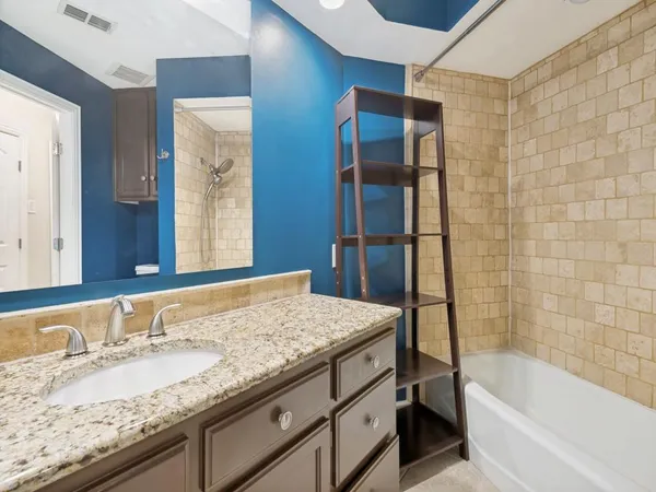 a kitchen with stainless steel appliances granite countertop white cabinets and a microwave oven