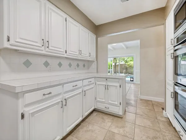 a view of kitchen with white cabinets