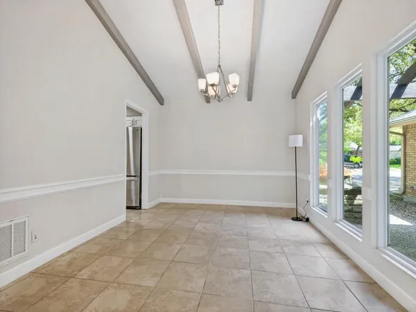a kitchen with a cabinets and chandelier