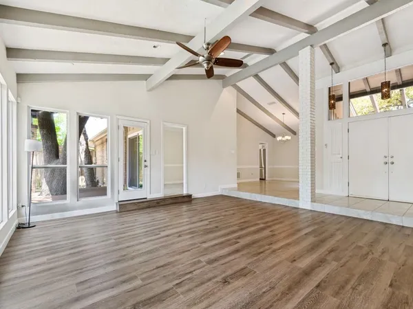 a view of empty room with wooden floor and fireplace