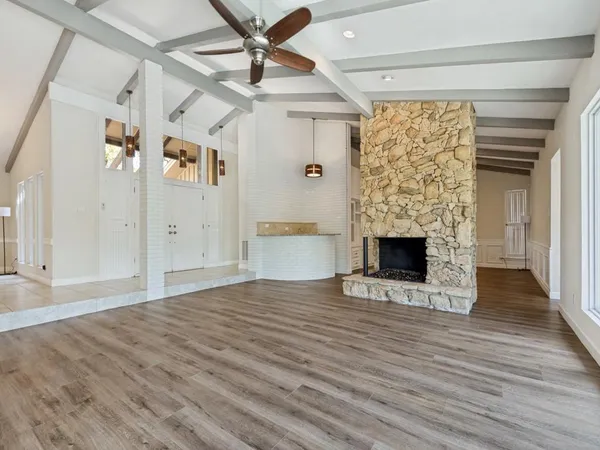 wooden floor in an empty room with a window