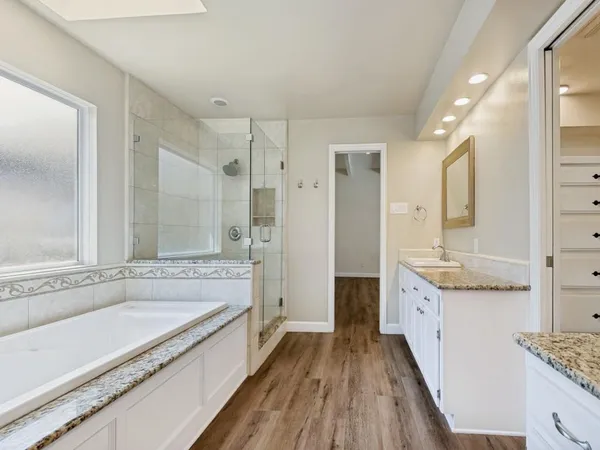 an empty room with closet and windows