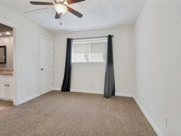 a bathroom with a granite countertop sink and shower