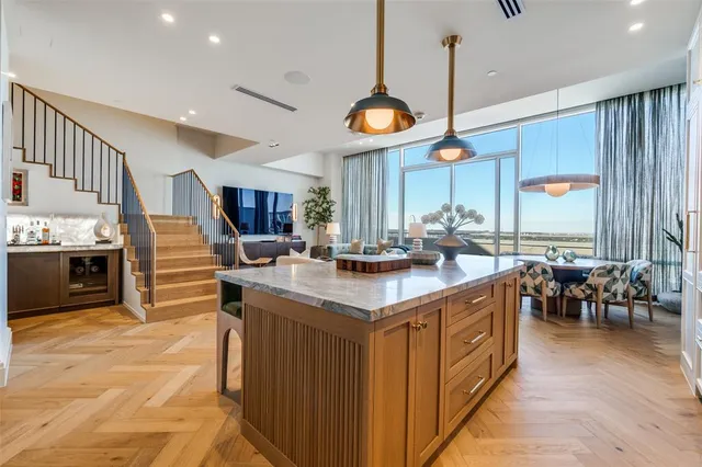 a kitchen with stainless steel appliances granite countertop a stove and a wooden floors