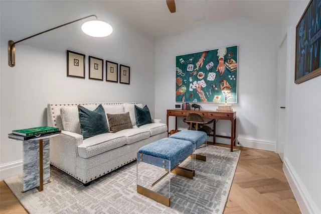a living room with furniture and a painting on the wall