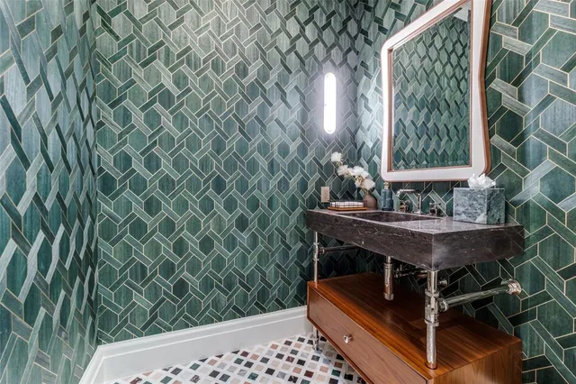 a bath room with a sink and a mirror