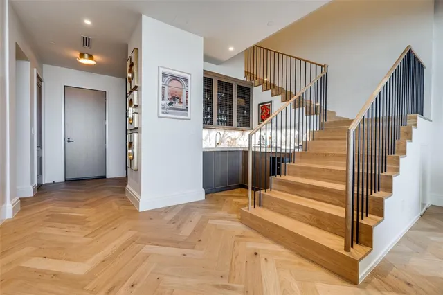 a view of entryway and hall with wooden floor