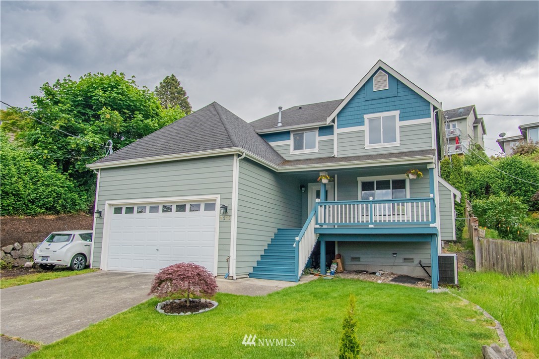 7215 South Rustic Road Seattle, WA 98178 - Photo 1 of 32 a front view of a house with a garden and deck