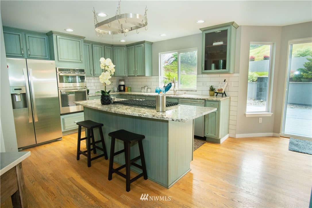 7215 South Rustic Road Seattle, WA 98178 - Photo 12 of 32 a kitchen with kitchen island a sink stove and refrigerator