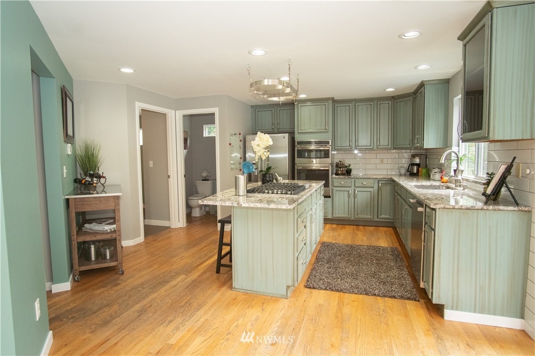 7215 South Rustic Road Seattle, WA 98178 - Photo 13 of 32 a large kitchen with a table and chairs in it
