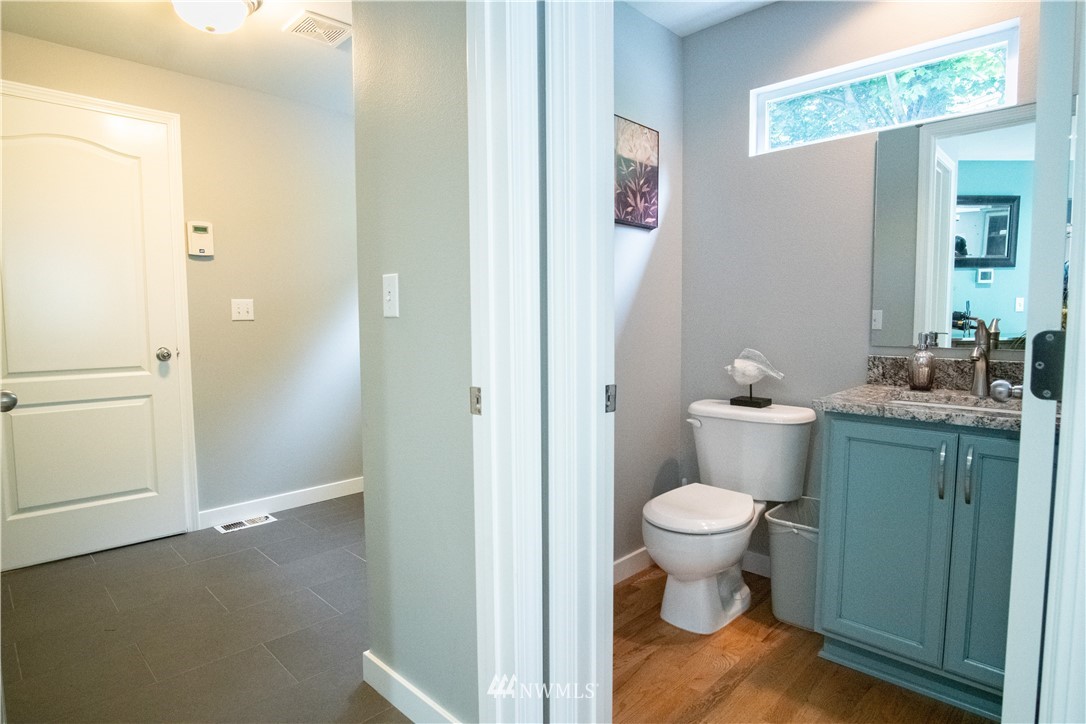 7215 South Rustic Road Seattle, WA 98178 - Photo 18 of 32 a view of bathroom with a toilet sink and a mirror