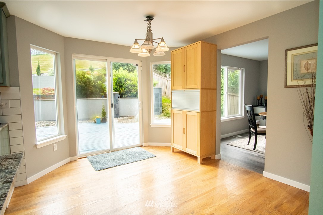 7215 South Rustic Road Seattle, WA 98178 - Photo 20 of 32 a bedroom with a bed and a chandelier