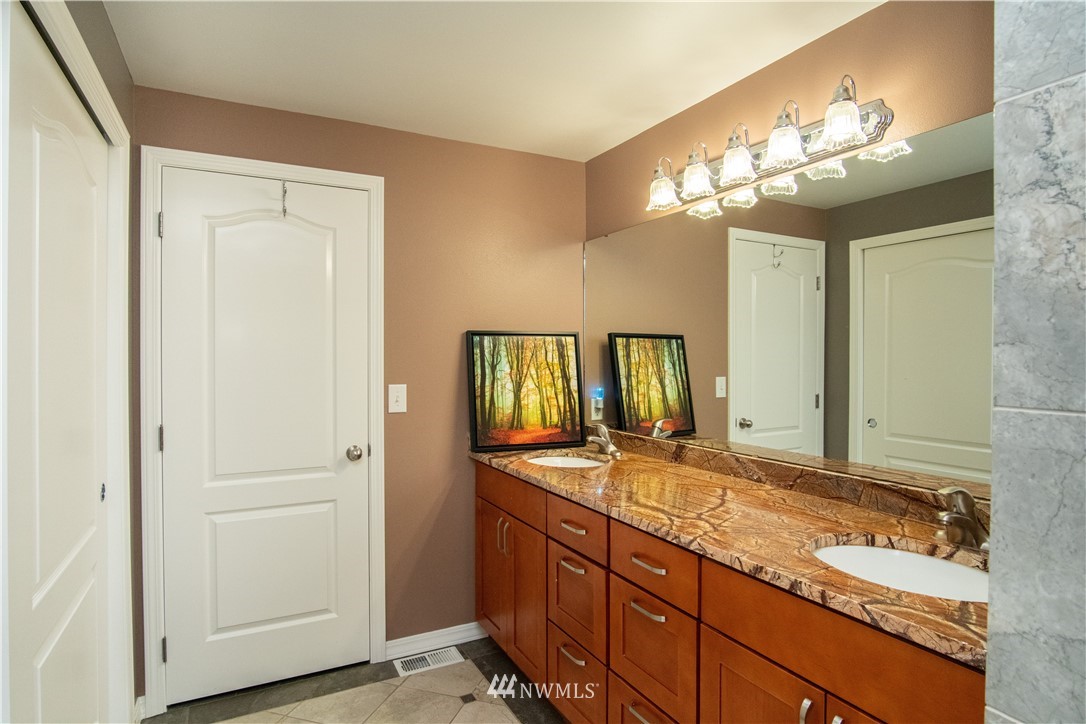 7215 South Rustic Road Seattle, WA 98178 - Photo 23 of 32 a bathroom with a granite countertop sink and a mirror