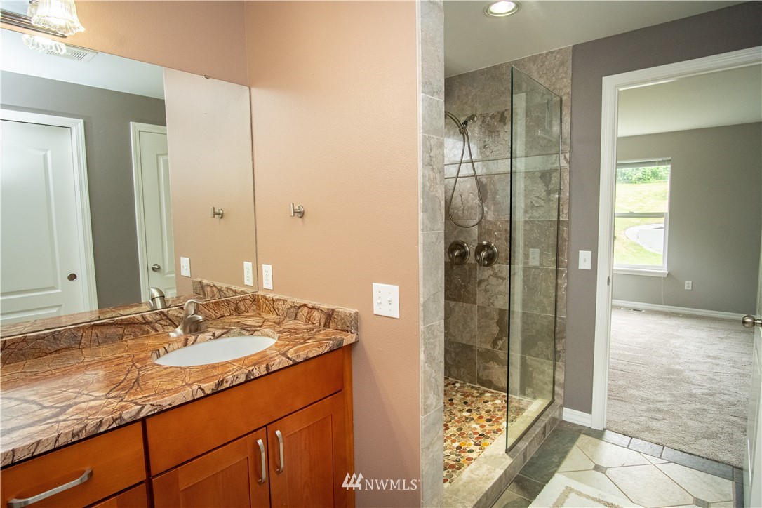 7215 South Rustic Road Seattle, WA 98178 - Photo 24 of 32 a bathroom with a shower sink and mirror