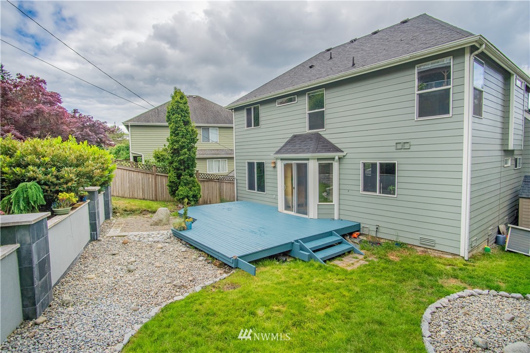 7215 South Rustic Road Seattle, WA 98178 - Photo 32 of 32 a front view of a house with a yard and garage